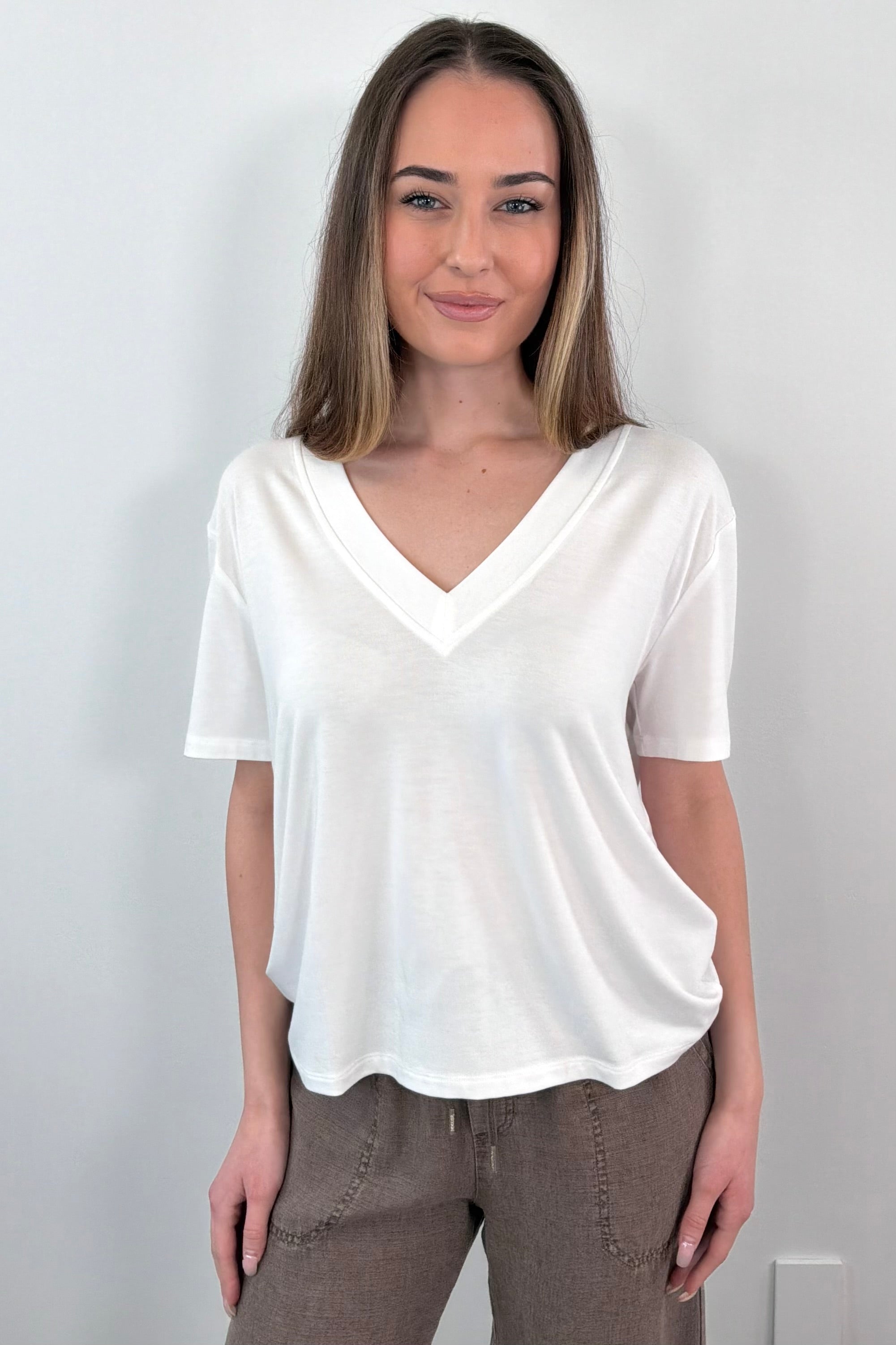 Woman wearing a white V-neck t-shirt 