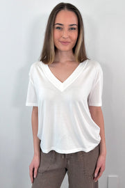 Woman wearing a white V-neck t-shirt 