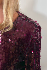 close-up of a maroon sequin long flared sleeves top