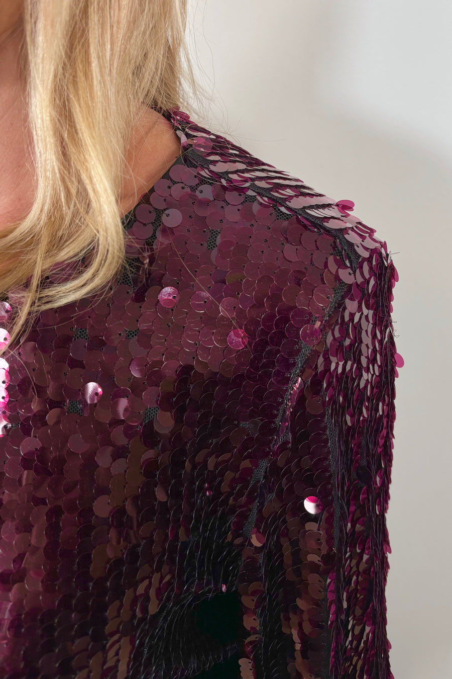 close-up of a maroon sequin long flared sleeves top