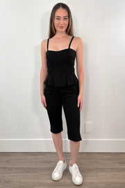 Woman wearing black capri pants