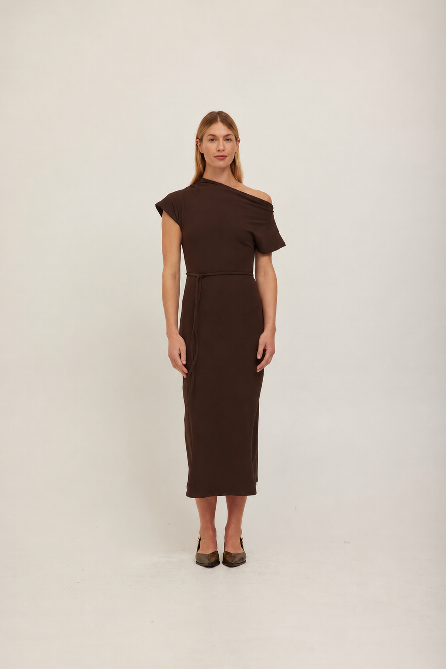 A woman modeling a dark brown off-the-shoulder midi dress with a fitted waist and short sleeves. 