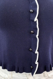 Close up of Woman wearing button up cropped top with collar with white details