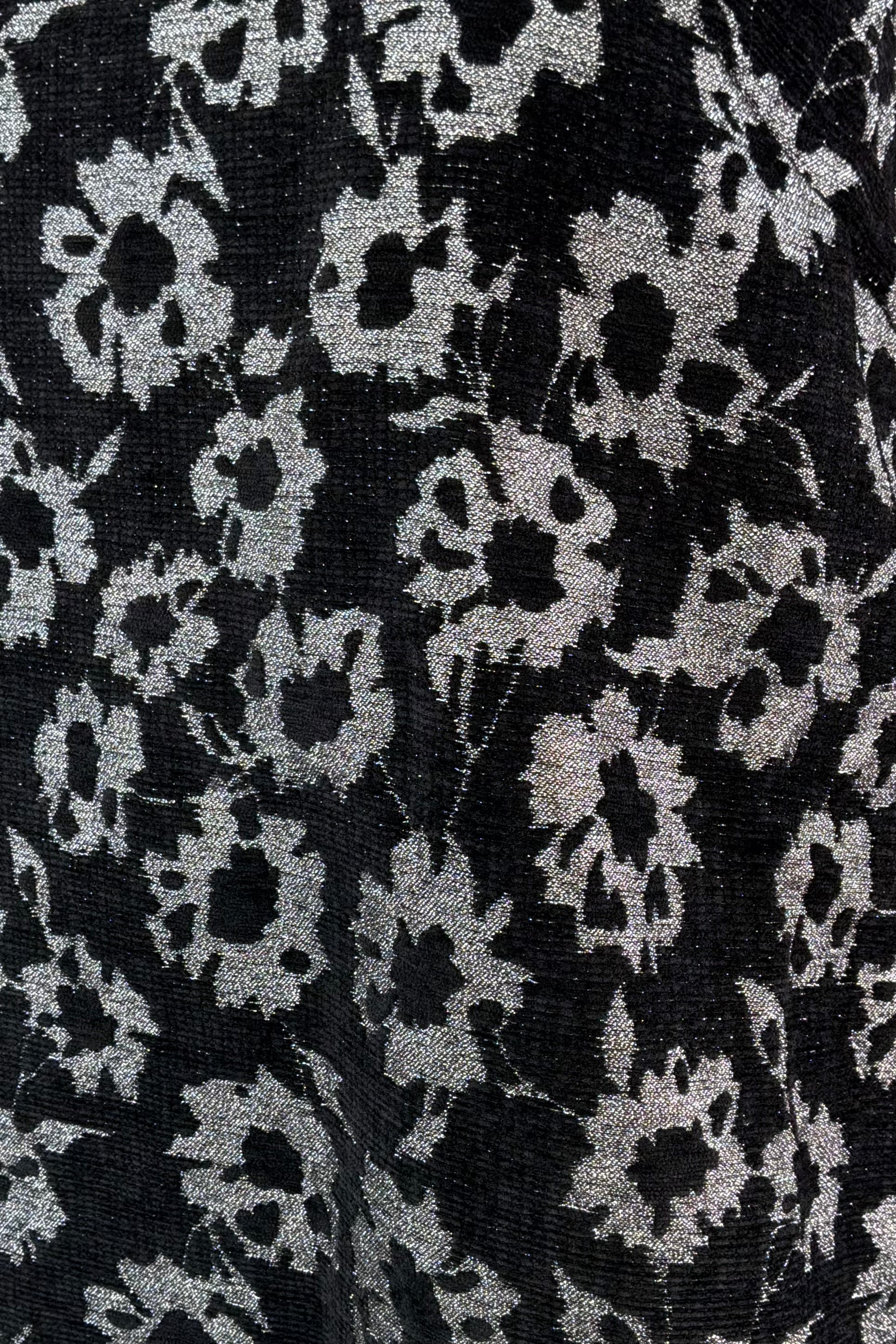 Close-up of black fabric with white floral pattern