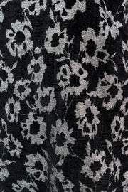 Close-up of black fabric with white floral pattern