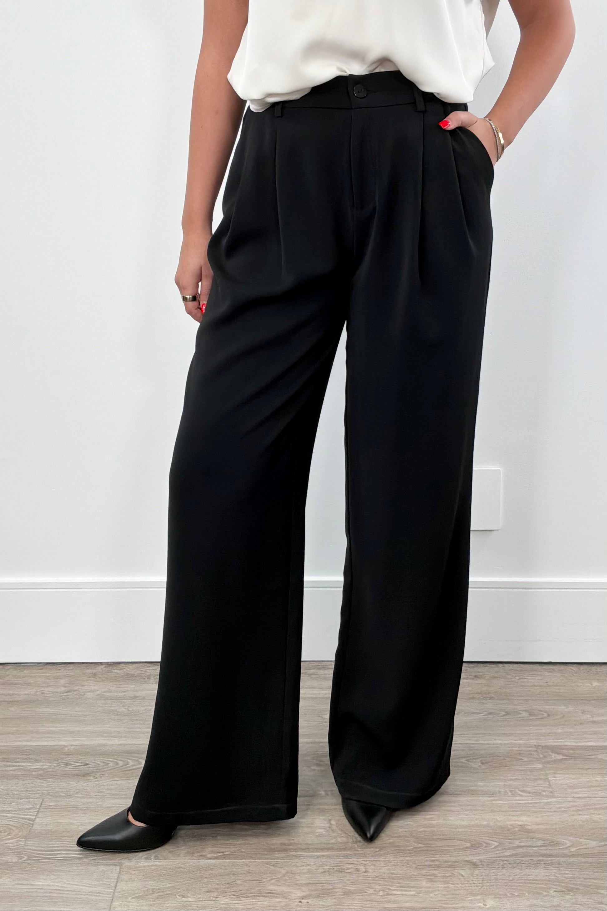Woman wearing black wide-leg pants. 