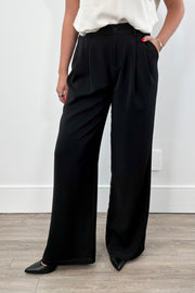 Woman wearing black wide-leg pants. 