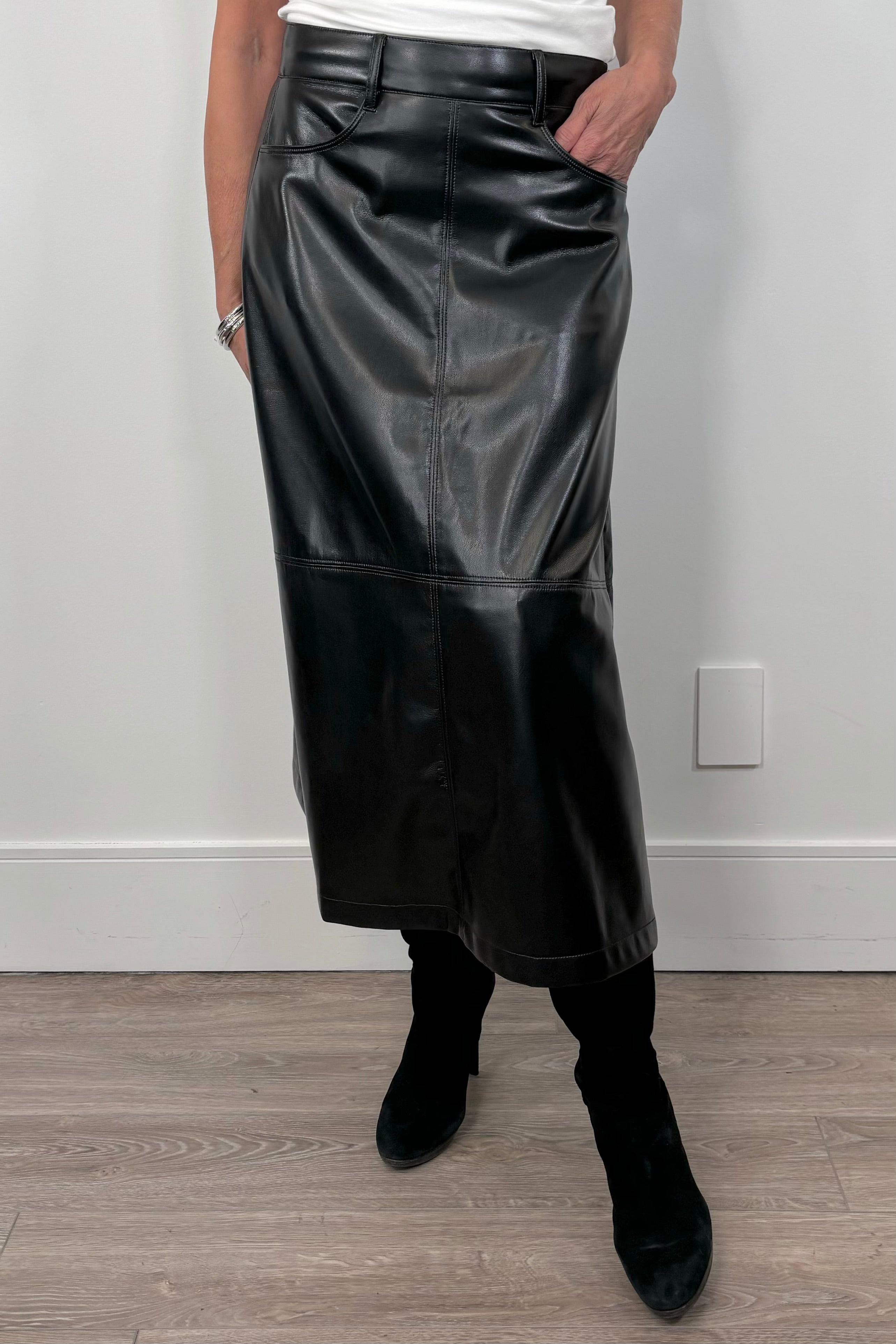 woman wearing a black faux leather skirt