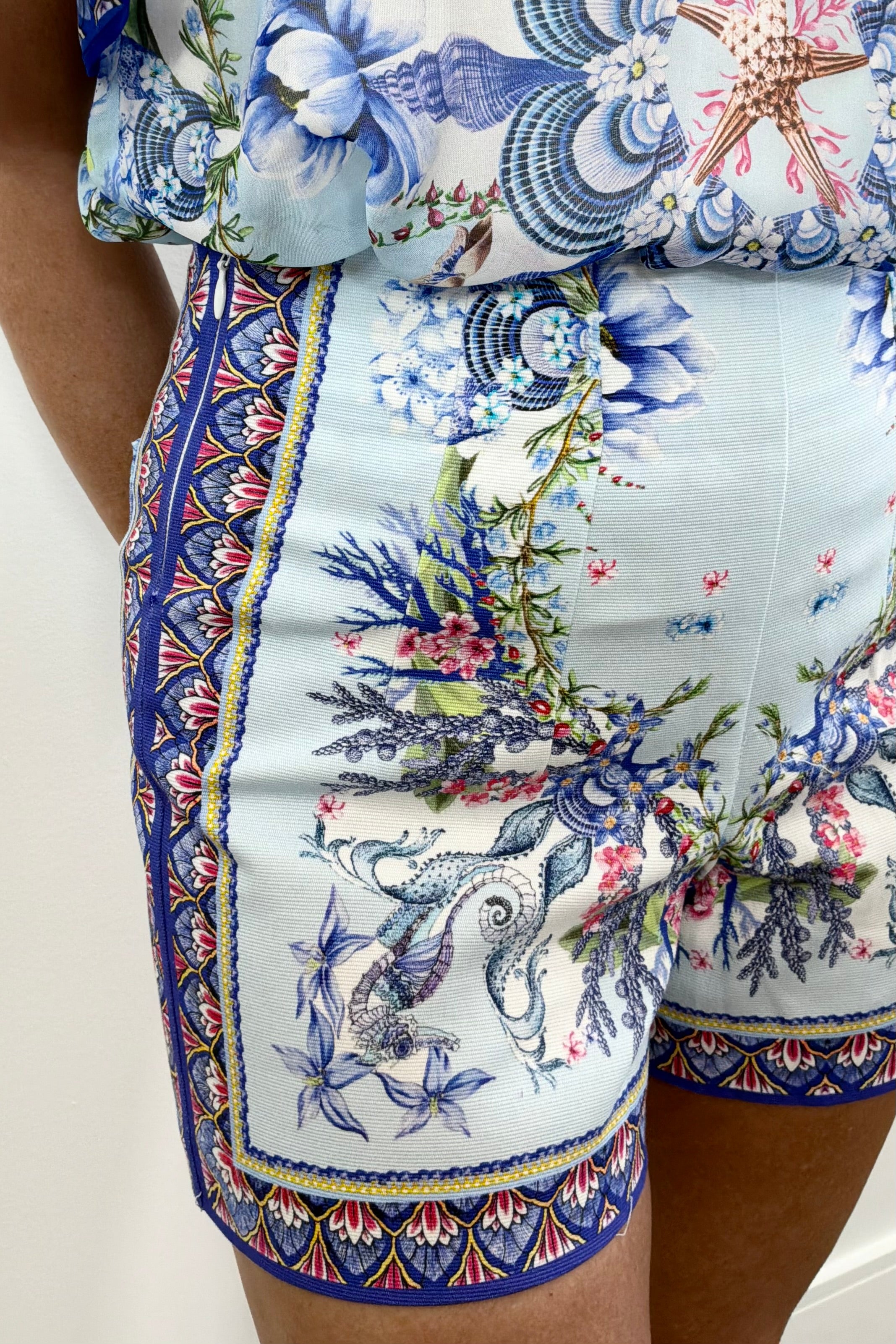 Women wearing blue shorts with a colourful floral pattern