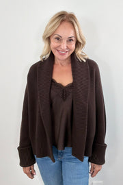 Woman wearing a brown knit cardigan. 