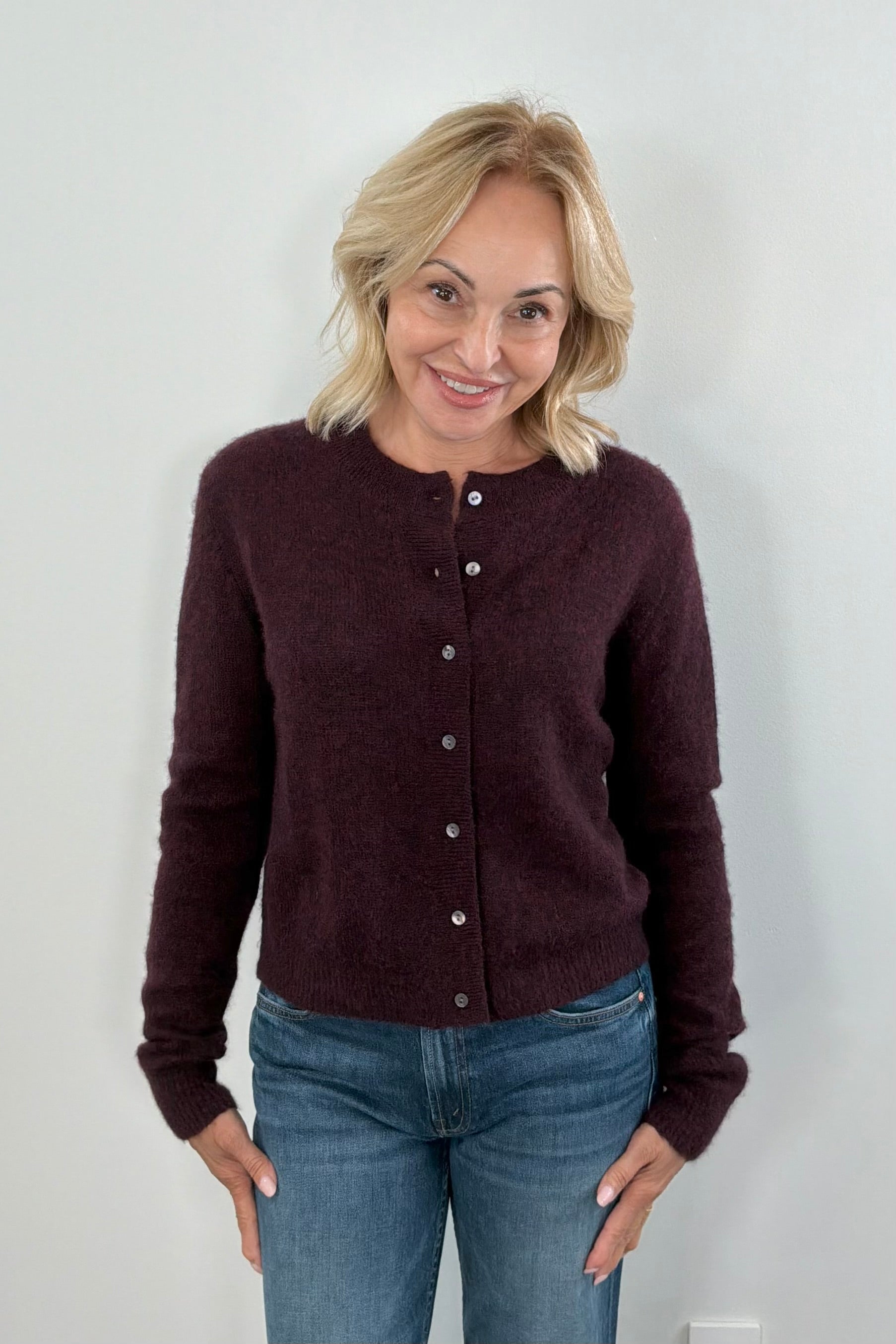Woman wearing a dark brown cashmere cardigan 
