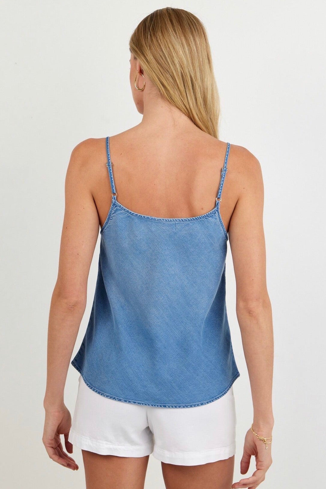 Back view of woman wearing a light indigo blue tank top