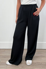 Person wearing black wide-leg pull on pants