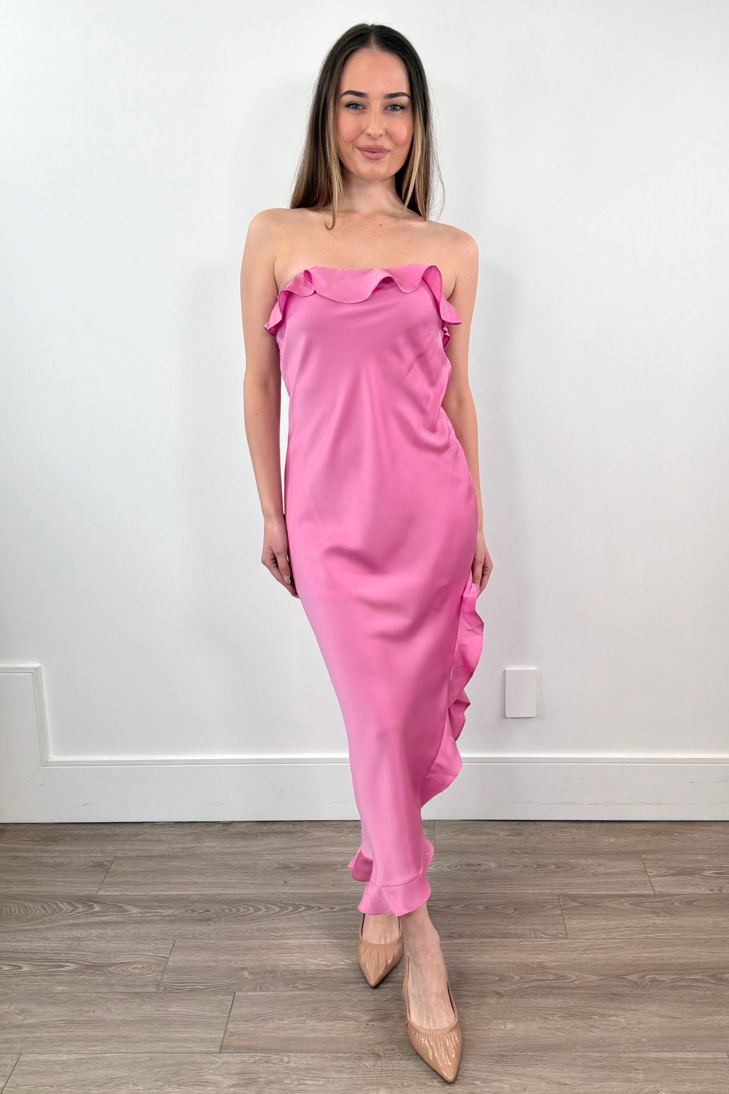 Woman wearing a pink strapless ruffle dress