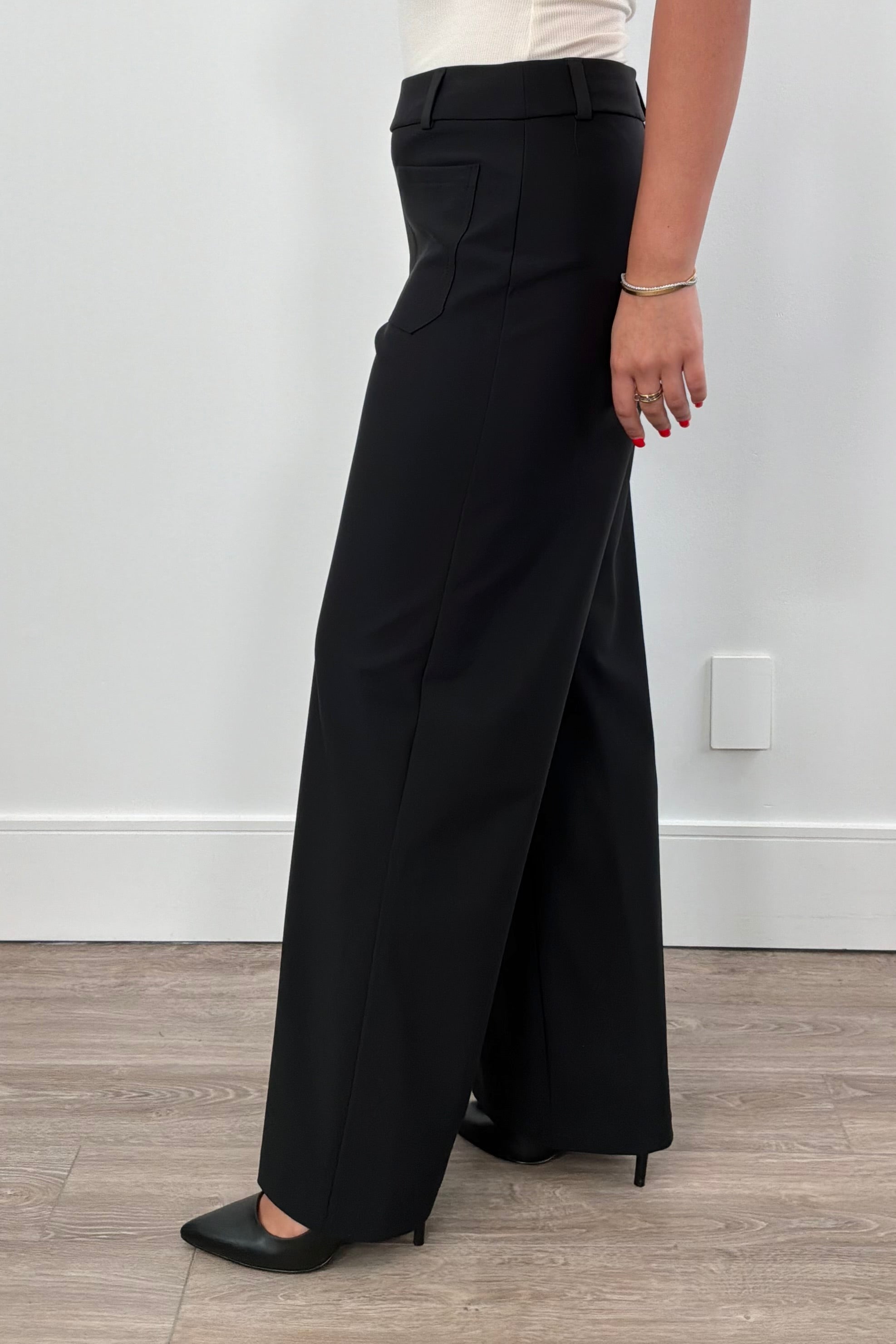 Sophisticated and effortlessly versatile, these wide-leg tailored pants feature a flattering high-rise waist, clean front patch pockets, and a fluid drape. Designed to pair seamlessly with blazers, blouses, or lightweight knits, they’re a timeless staple for work and beyond.