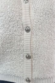 Close-up of a textured cardigan with button details
