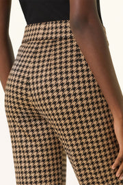 Back view of woman wearing a houndstooth knit pant