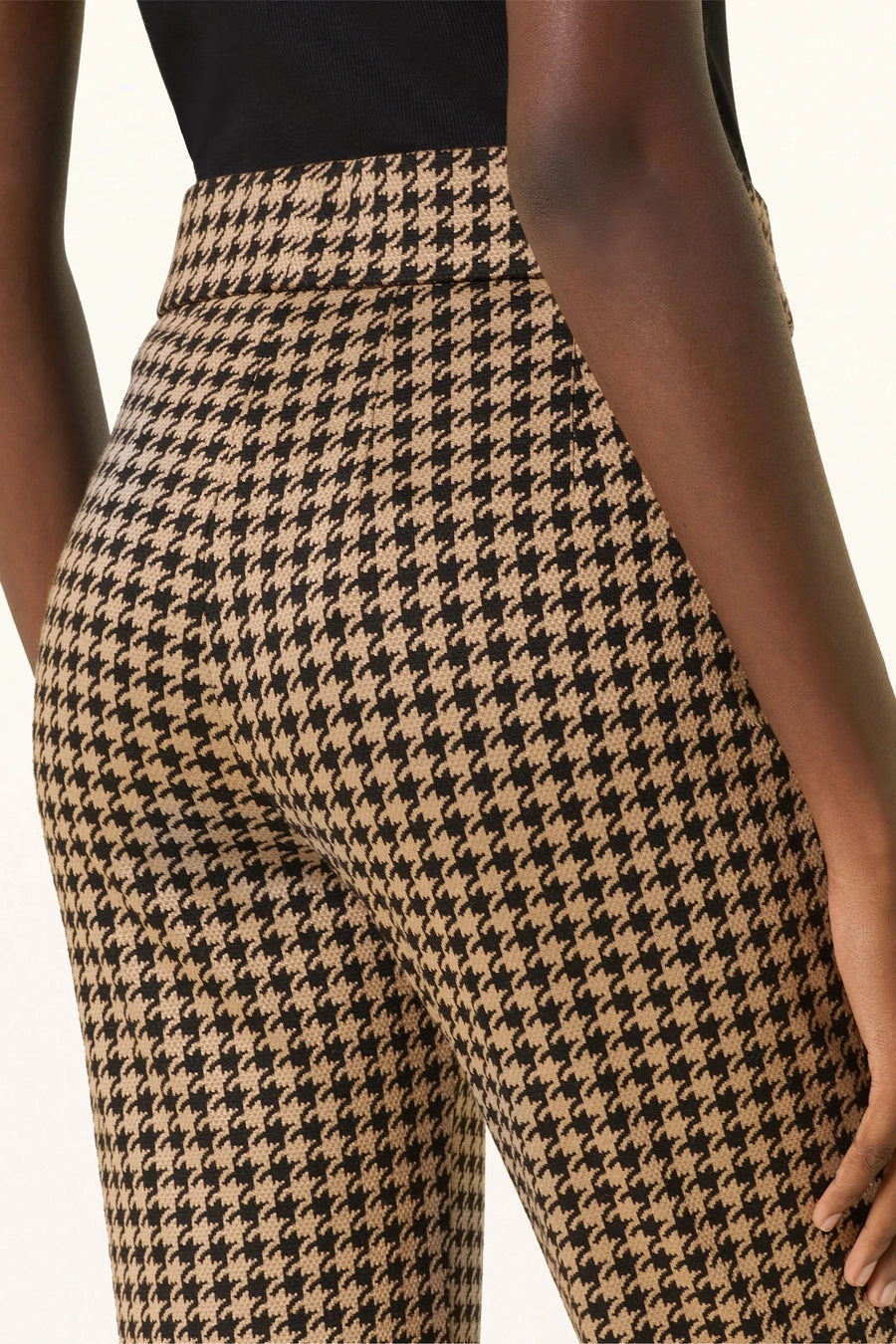 Back view of woman wearing a houndstooth knit pant