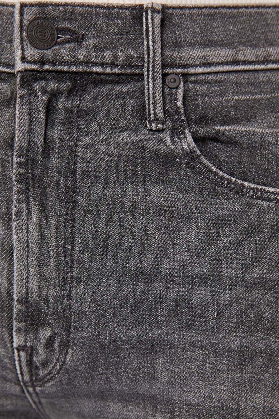 Zoom in view of a person wearing gray high-rise, straight leg, and cropped ankle-length hem