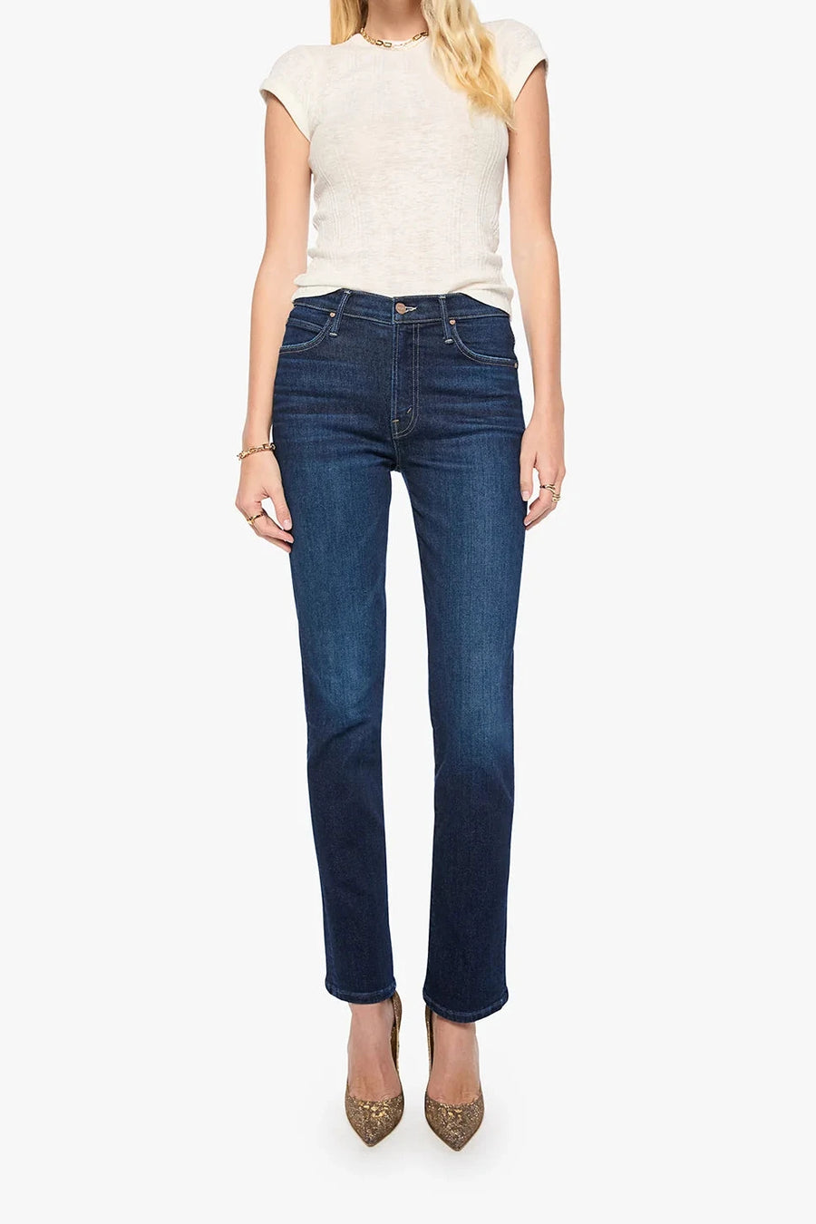 Woman wearing blue jeans and a white top on a white background
