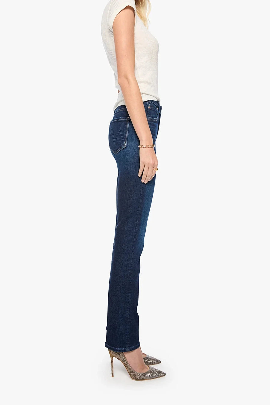 Woman wearing blue jeans and a white top on a white background