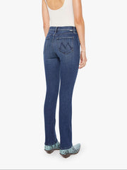 Woman wearing a white tank top and blue mid-rise, straight leg jeans on a white background from the back