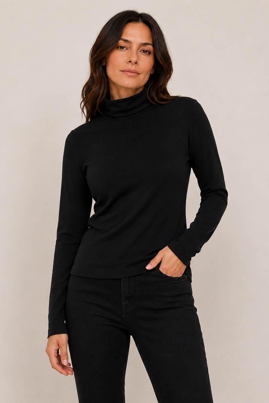 A woman modeling a black long-sleeve turtleneck top 