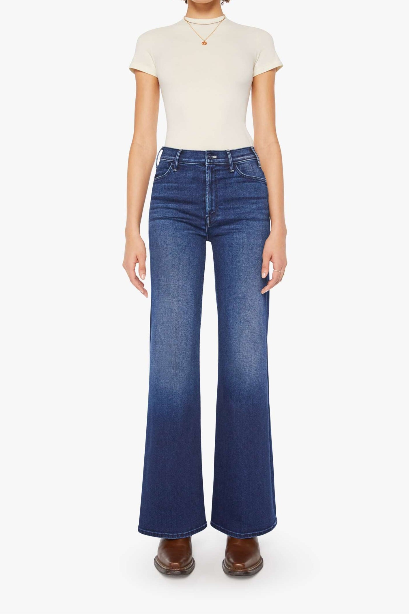 Front view of a person wearing a blue, wide leg, high rise, and clean hem jean