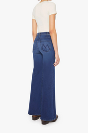 Front view of a person wearing a blue, wide leg, high rise, and clean hem jean