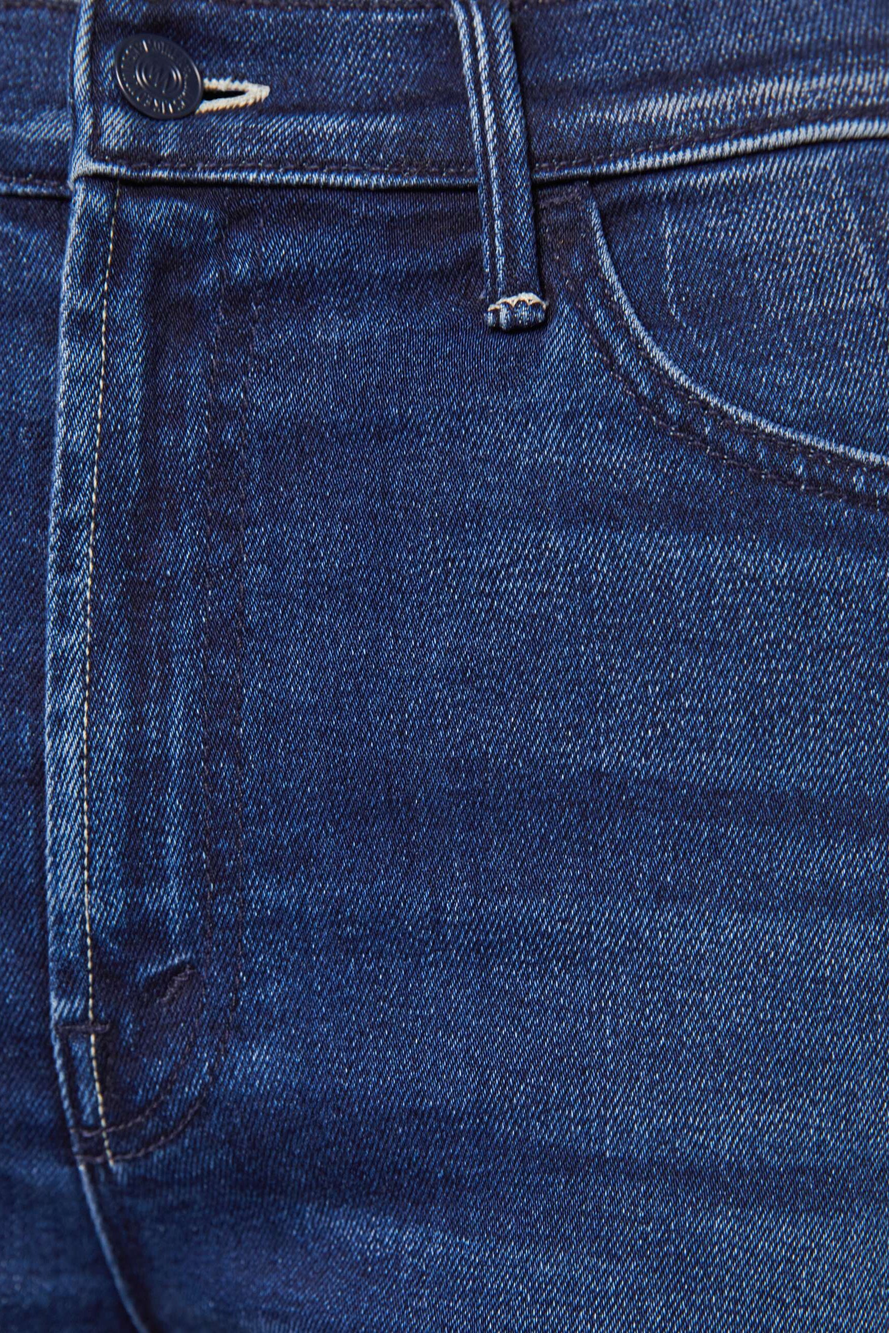 Front zoom in view of a person wearing a blue, wide leg, high rise, and clean hem jean