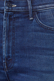 Front zoom in view of a person wearing a blue, wide leg, high rise, and clean hem jean