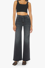 Front view of a person wearing a washed black, wide leg, high rise, and clean hem jean