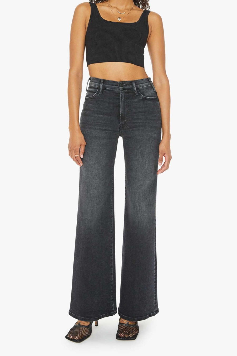 Front view of a person wearing a washed black, wide leg, high rise, and clean hem jean