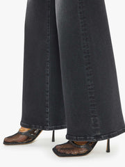 Side zoom in view of a person wearing a washed black, wide leg, high rise, and clean hem jean