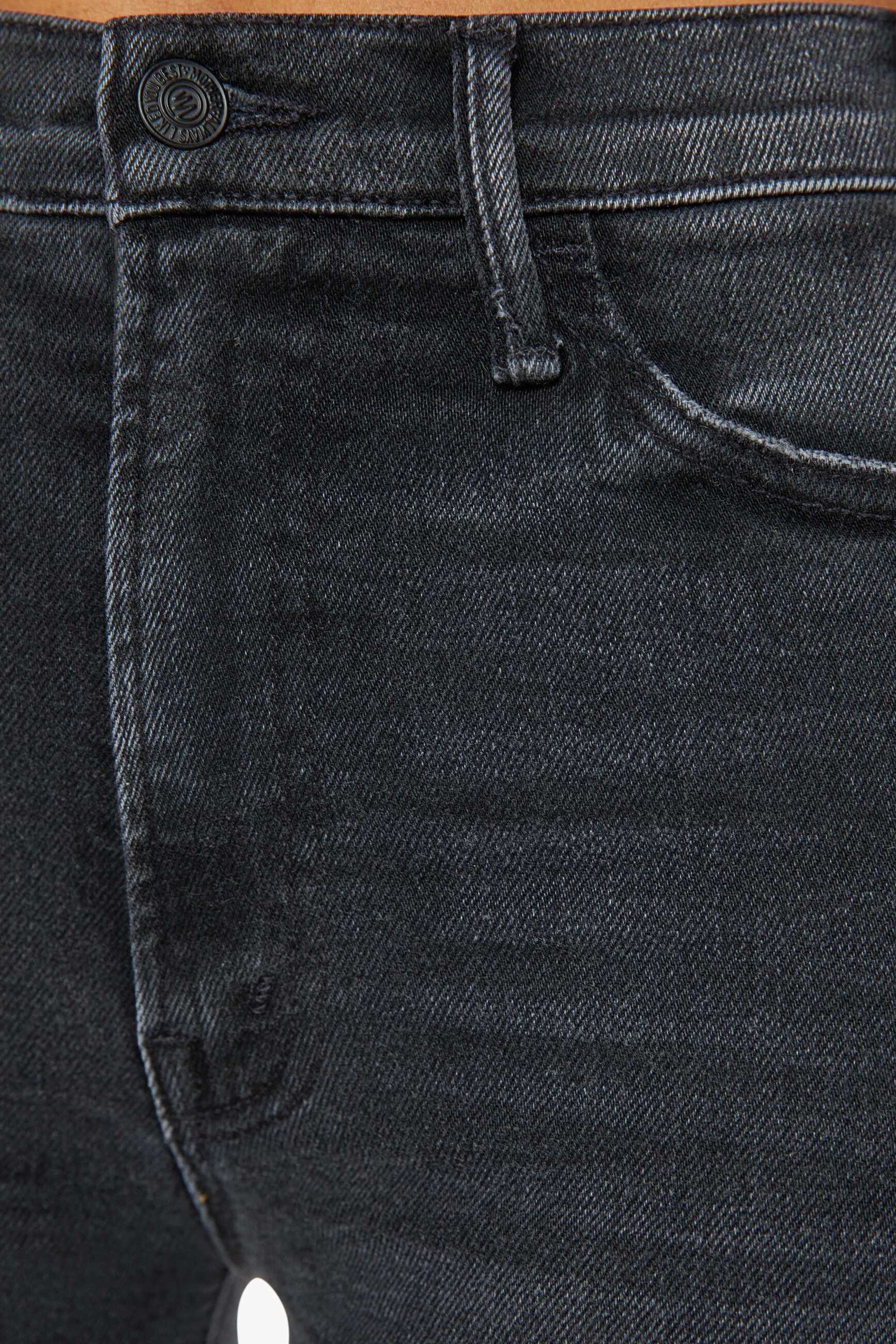 Front zoom in view of a person wearing a washed black, wide leg, high rise, and clean hem jean