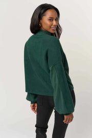 woman wearing a green fleece Henley sweatshirt
