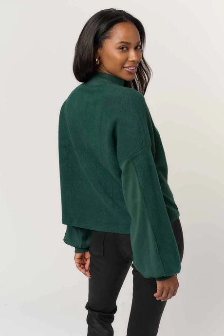 woman wearing a green fleece Henley sweatshirt