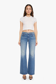 woman wearing mid rise boot cut light wash jeans 