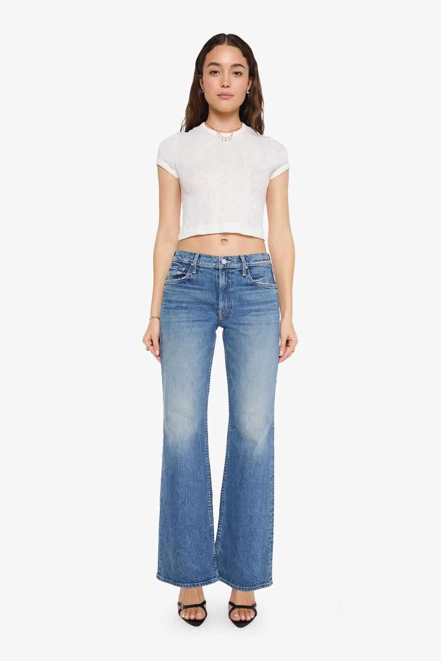 woman wearing mid rise boot cut light wash jeans 