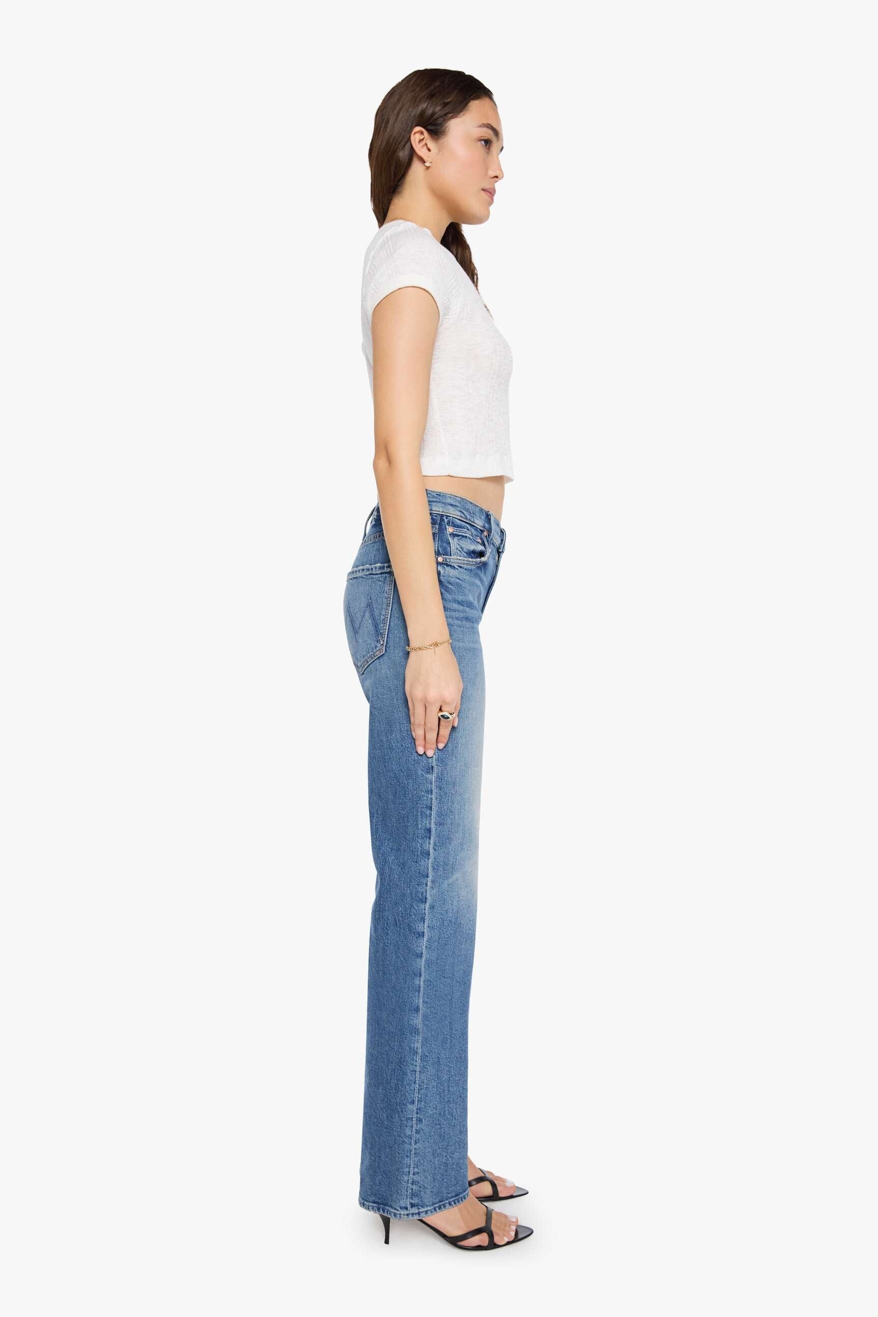woman wearing mid rise boot cut light wash jeans 
