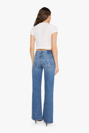 woman wearing mid rise boot cut light wash jeans 