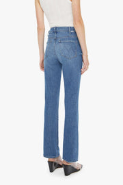 back view of woman wearing washed blue denim with a small flare at the bottom