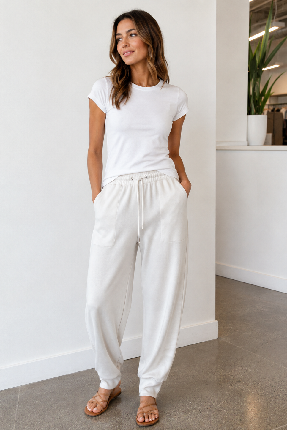 A woman modeling white drawstring sweatpants,