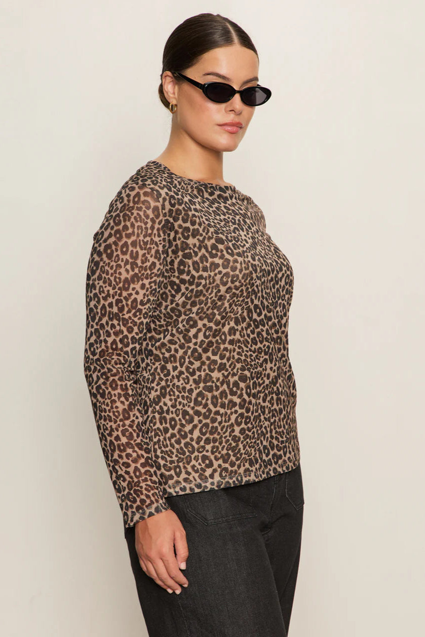 Side view of woman wearing a lined long sleeve leopard print mesh top