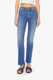Front view of a person wearing blue mid-rise waist and a narrow flare leg jean