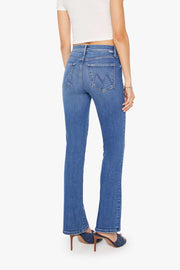 Back view of a person wearing blue mid-rise waist and a narrow flare leg jean