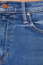 Front zoom in view of a person wearing blue mid-rise waist and a narrow flare leg jean