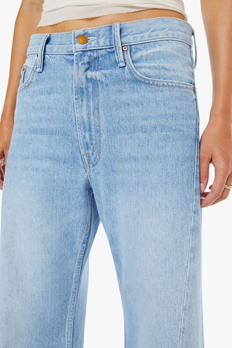 close up of woman wearing light blue washed wide leg denim