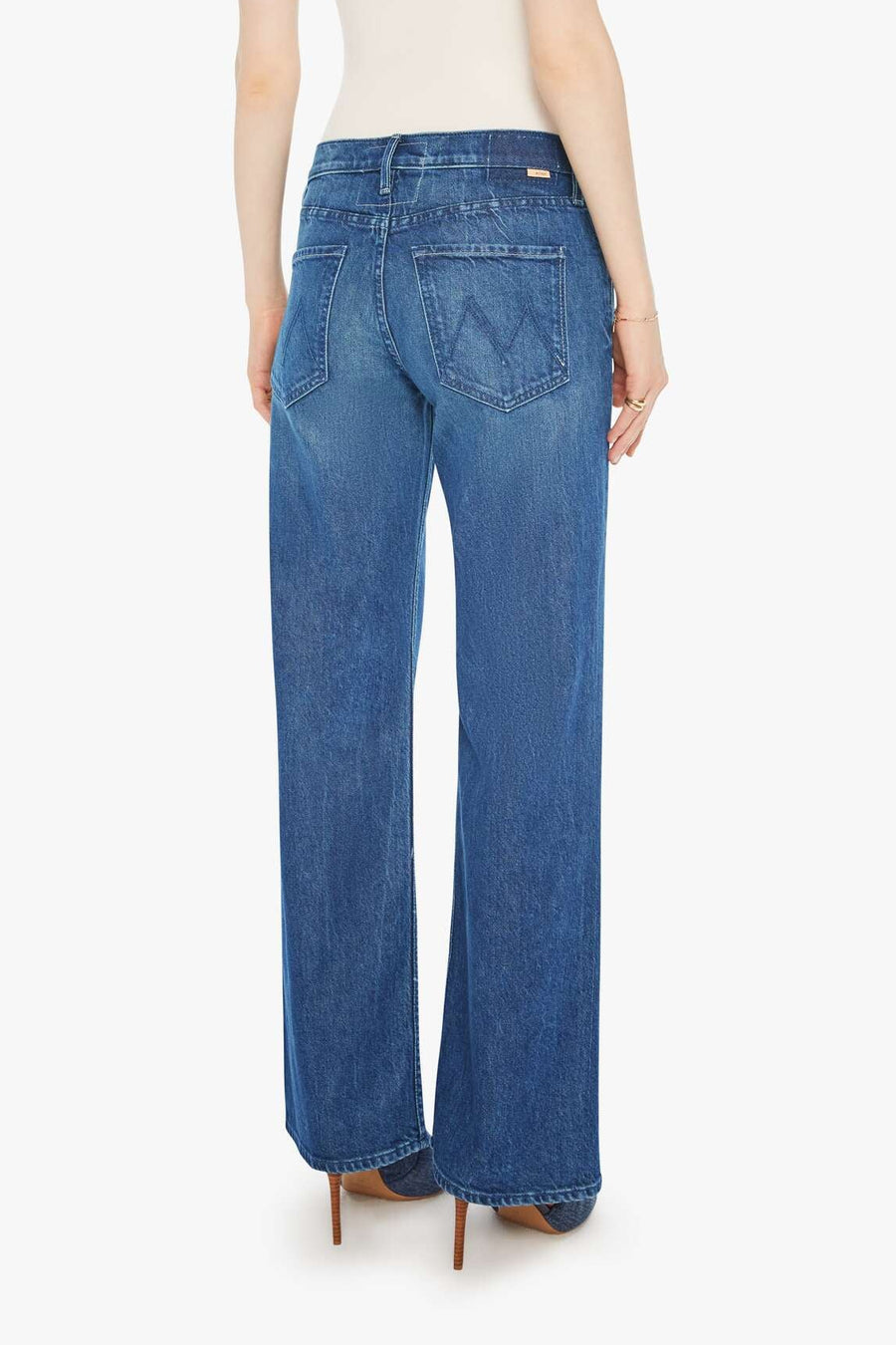 Woman wearing blue jeans on a white background