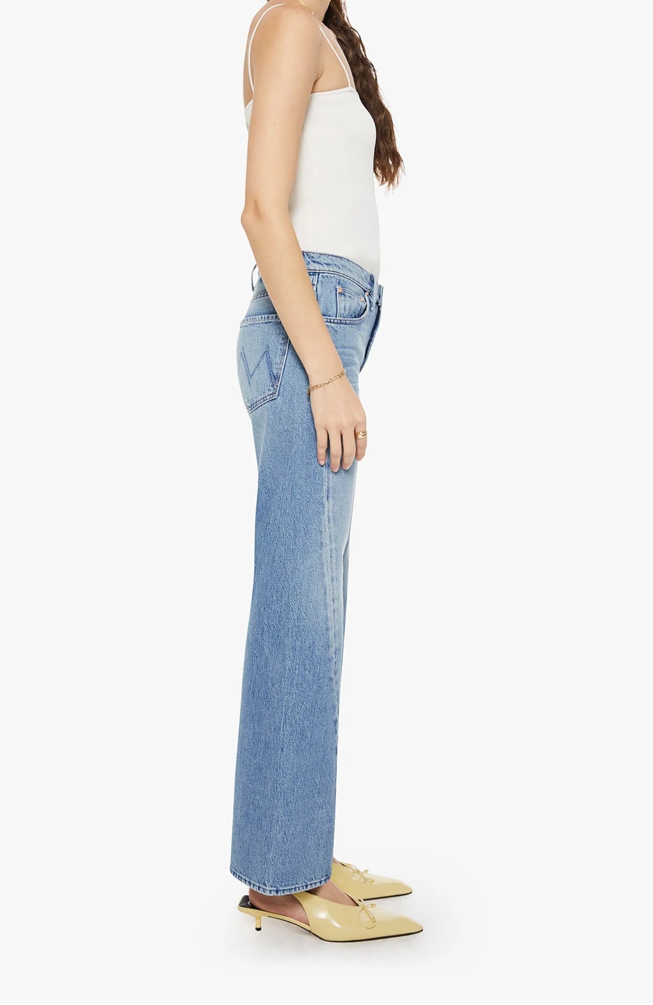 Woman wearing light blue flared jeans with a twist detail